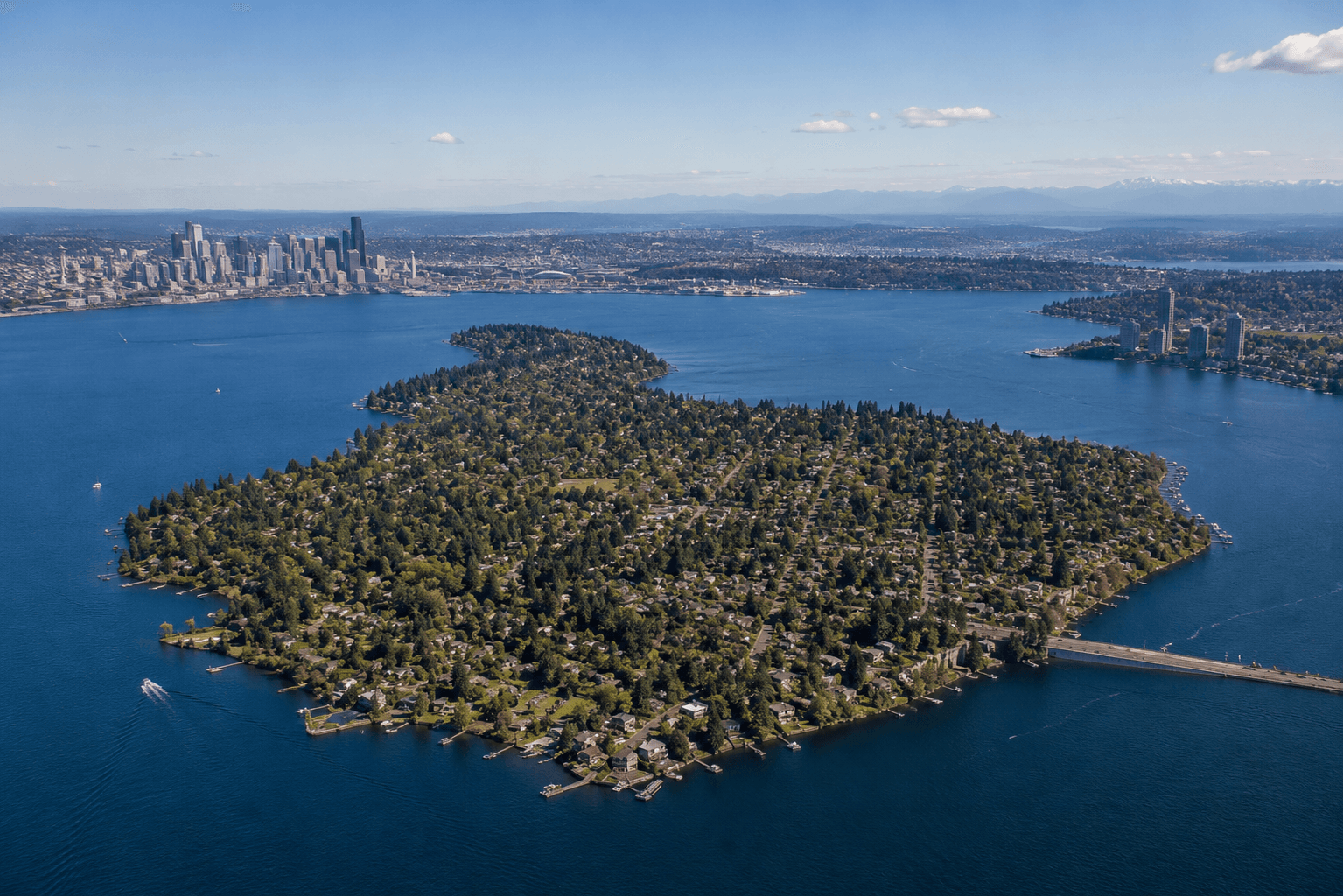 Aerial view of Mercer Island surrounded by Lake Washington with Seattle skyline beyond